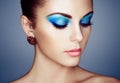 Portrait of young beautiful woman with blue makeup