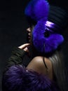 Portrait of young beautiful woman in blue purple fashion arctic fox winter fur ear flap hat Royalty Free Stock Photo