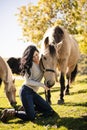 A Portrait of young beautiful woman with brown horse outdoors Royalty Free Stock Photo