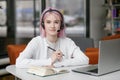 Portrait of young beautiful woman, business woman smiling and looking at camera, receptionist using headset for video call, happy Royalty Free Stock Photo