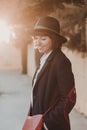 portrait of a young beautiful woman with casual clothing smiling at sunset, back light. City background Royalty Free Stock Photo