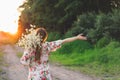 Portrait young beautiful woman with chamomile flowers at sunset. Royalty Free Stock Photo