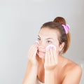 Portrait of young beautiful woman cleaning her face Royalty Free Stock Photo