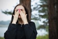 Portrait of young beautiful woman crying in park in nature. concept of breaking up with your husband or boyfriend