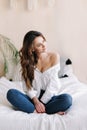 Portrait of a young beautiful woman in bed in the morning at home. Beautiful brunette in the bedroom. Good morning. Lifestyle. Royalty Free Stock Photo