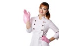 Portrait of young beautiful woman doctor nurse in white special gown and gloves standing and putting off mask from face