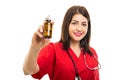 Portrait of doctor wearing scrubs holding bottle of pills Royalty Free Stock Photo