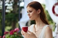 Portrait of young beautiful woman drinking coffee outdoors unaltered Royalty Free Stock Photo