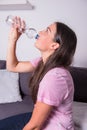 Portrait of a young beautiful woman drinking water out of the bo Royalty Free Stock Photo