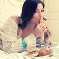 Portrait of a young beautiful woman eating her croissant Royalty Free Stock Photo