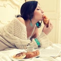 Portrait of a young beautiful woman eating her croissant with st Royalty Free Stock Photo