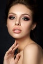 Portrait of young beautiful woman with evening make up touching Royalty Free Stock Photo