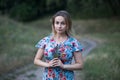 Portrait of young beautiful woman in flower dress holding flowers in her hands Royalty Free Stock Photo