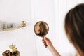 Portrait of a young beautiful woman. Girl looks at herself in the mirror. makeup model. Morning of the bride. Wedding preparations