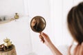 Portrait of a young beautiful woman. Girl looks at herself in the mirror. makeup model. Morning of the bride. Wedding preparations