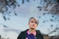 Portrait of a young beautiful woman in green coat with a short haircut and dyed hair. Grey main color and yellow, green Royalty Free Stock Photo