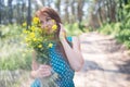 Young beautiful woman with green eyes holding yellow flowers Royalty Free Stock Photo