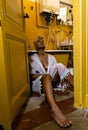 Portrait of a young beautiful woman in her old fashioned yellow bathroom