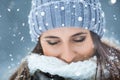 Portrait of young beautiful woman from his eyes closed in the winter snowing