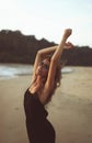 Portrait of a young beautiful woman with long curly hair at the seaside