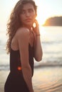 Portrait of a young beautiful woman with long curly hair at the seaside Royalty Free Stock Photo