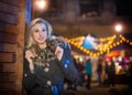 Portrait of young beautiful woman with long fair hair outdoor in cold winter evening. Beautiful blonde girl in winter clothes Royalty Free Stock Photo