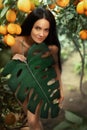 Portrait young beautiful woman in mage of primitive woman Eve. sexy girl walks in Divine Garden of Eden, covering naked