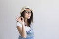 portrait of a young beautiful woman with modern glasses and hat. White background. Millennial. Hipster and lifestyle.Making the ok Royalty Free Stock Photo