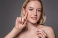 Portrait of young beautiful woman with natural makeup and contact eye lens in hand. Close-up of female model holding Royalty Free Stock Photo