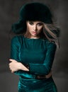 Portrait of young beautiful woman in new green fashion arctic fox winter fur ear flaps Royalty Free Stock Photo