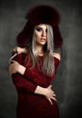 Portrait of young beautiful woman in new red fashion arctic fox winter fur ear flaps Royalty Free Stock Photo