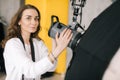 Portrait of young beautiful woman photographer prepares light equipment softbox Royalty Free Stock Photo