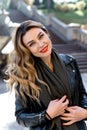 Portrait of young beautiful woman with red lipstick and long blonde curled hair Royalty Free Stock Photo