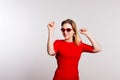 Portrait of a young beautiful woman with red sunglasses in studio. Royalty Free Stock Photo