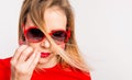 Portrait of a young beautiful woman with red sunglasses in studio. Royalty Free Stock Photo