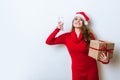 Portrait of young beautiful woman in Santa hat with champagne glass and gift box. Royalty Free Stock Photo