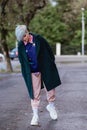 Portrait of a young beautiful woman with a short haircut and dyed hair. Grey main color and yellow, green, blue and red Royalty Free Stock Photo