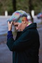 Portrait of a young beautiful woman with a short haircut and dyed hair. Grey main color and yellow, green, blue and red Royalty Free Stock Photo