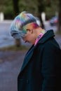 Portrait of a young beautiful woman with a short haircut and dyed hair. Grey main color and yellow, green, blue and red Royalty Free Stock Photo