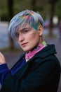 Portrait of a young beautiful woman with a short haircut and dyed hair. Grey main color and yellow, green, blue and red Royalty Free Stock Photo