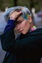 Portrait of a young beautiful woman with a short haircut and dyed hair. Grey main color and yellow, green, blue and red Royalty Free Stock Photo