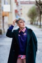 Portrait of a young beautiful woman with a short haircut and dyed hair. Grey main color and yellow, green, blue and red Royalty Free Stock Photo