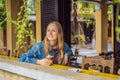 Portrait of young beautiful woman sitting in a cafe outdoor drinking coffee Royalty Free Stock Photo