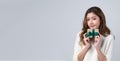 Portrait of young beautiful woman smiling with happiness and holding present box in front of her to celebrate the festive season, Royalty Free Stock Photo