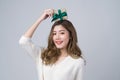 Portrait of young beautiful woman smiling with happiness and holding present box on her head to celebrate the festive season, Royalty Free Stock Photo