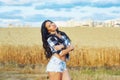 Portrait of a young beautiful woman on a summer walk near the wheat field Royalty Free Stock Photo