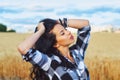 Portrait of a young beautiful woman on a summer walk near the wheat field Royalty Free Stock Photo