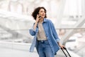 Portrait Of Young Beautiful Woman Talking On Mobile Phone At Airport Royalty Free Stock Photo