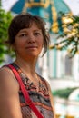 Portrait, young beautiful woman tourist, in the background in the blurred background. St. Andrew church in Kiev. Ukraine. Concept Royalty Free Stock Photo