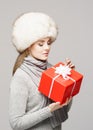 Portrait of a young and beautiful woman in a winter hat with Christmas present Royalty Free Stock Photo